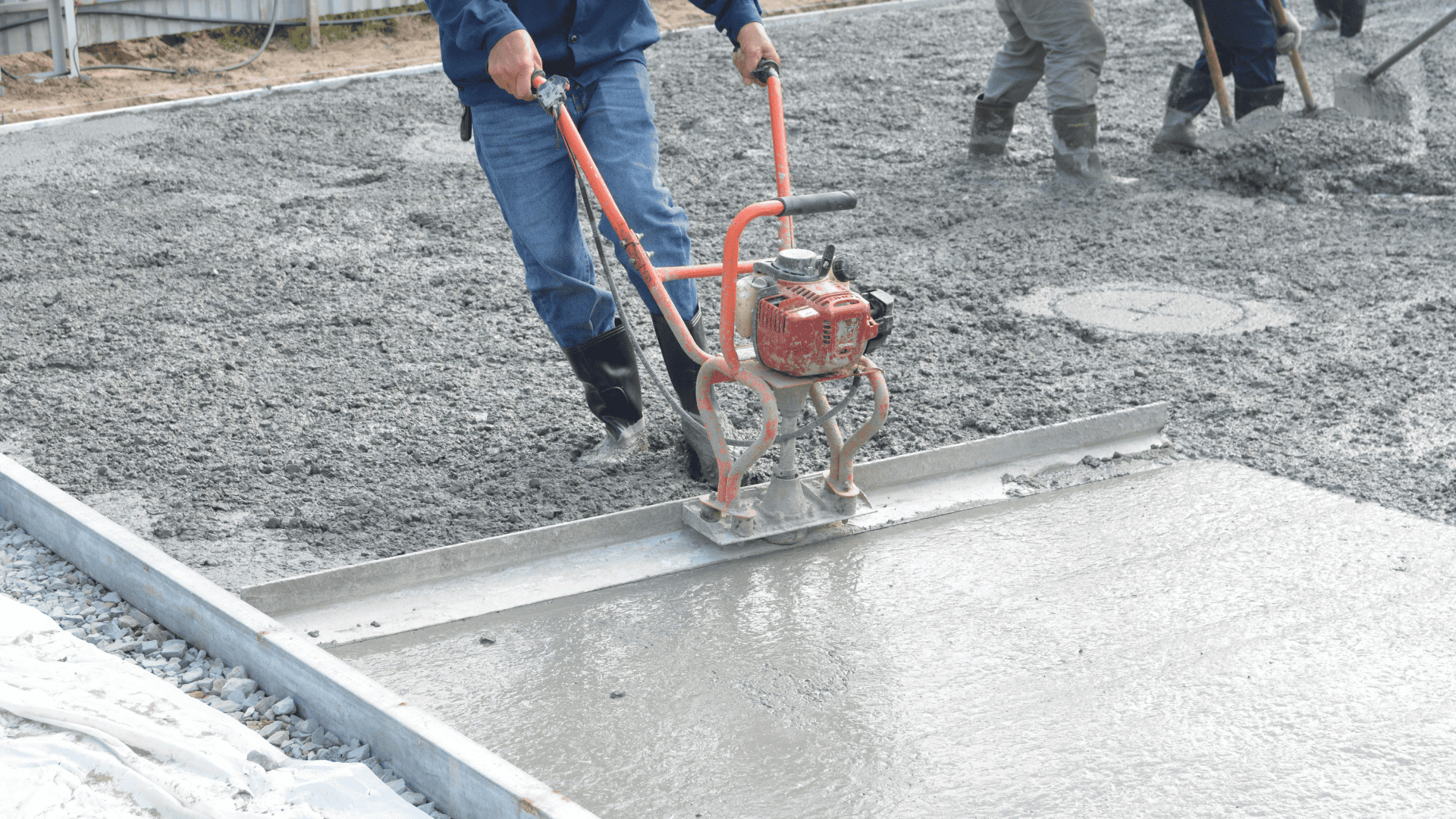 Concrete foundation being poured and leveled