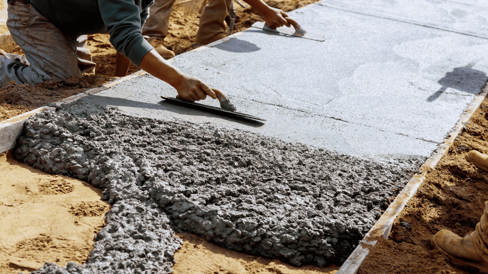 Concrete sidewalk being smoothed