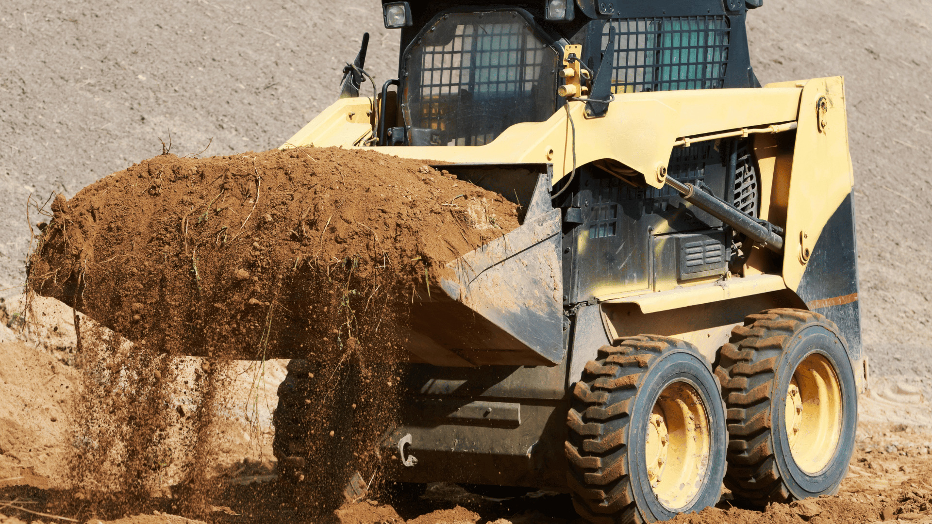 Skid steer performing excavation and site preparation